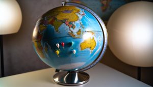 Un globe terrestre avec sept marqueurs indiquant les différents pays où il est possible de vivre avec un budget serré.