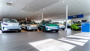 Une rangée de voitures électriques Ford dans un showroom ou un parking de concessionnaire.